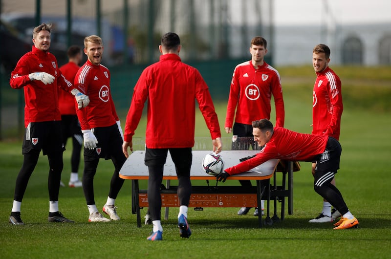 Wales' Connor Roberts and teammates around the Teqball table during training. Reuters