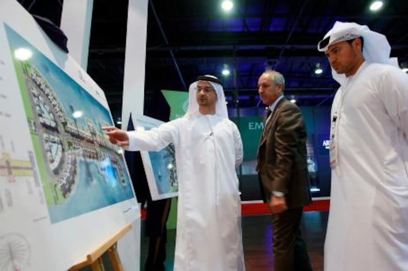 Dubai , United Arab Emirates- September 27,  2011:    Visitors browse the  Artist Impression of the New  Palm Residence  at  Palm Jumeirah launched at Cityscape Global in Dubai.  ( Satish Kumar / The National ) For Business