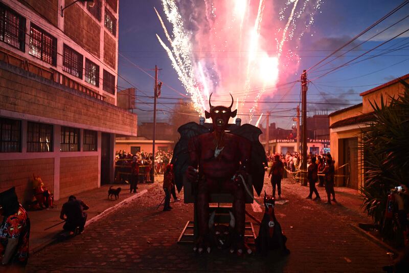 Fireworks explode above a devil's figure before being set ablaze during celebrations in honour of the Virgin of the Immaculate Conception in Guatemala City. AFP