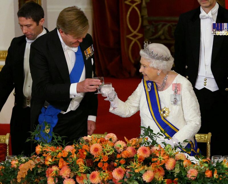 Queen Elizabeth II makes a toast with King Willem-Alexander of the Netherlands, during a state banquet at the Buckingham Palace in London. Yui Mok / Reuters