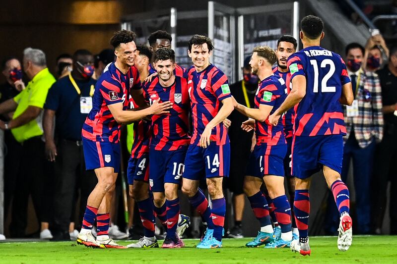 USA's Christian Pulisic celebrates with teammates after scoring. AFP