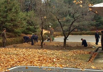 North Korean soldiers dig a trench and plant trees in the area where, on November 13, a defector ran across the border at the Demilitarized Zone (DMZ) dividing North Korea and South Korea November 22, 2017. Picture taken November 22, 2017.   Handout via REUTERS  ATTENTION EDITORS - THIS IMAGE WAS PROVIDED BY A THIRD PARTY. THIS PICTURE WAS PROCESSED BY REUTERS TO ENHANCE QUALITY. AN UNPROCESSED VERSION HAS BEEN PROVIDED SEPARATELY. NO RESALES. NO ARCHIVE.     TPX IMAGES OF THE DAY