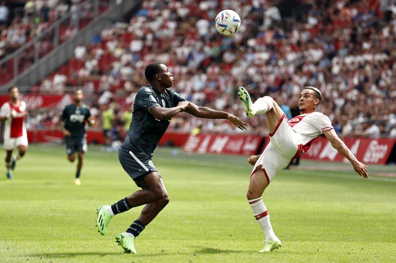 Jax's Antony and Neraysho Kasanwirjo of Groningen battle for the ball at the Johan Cruyff Arena on August 14, 2022. EPA