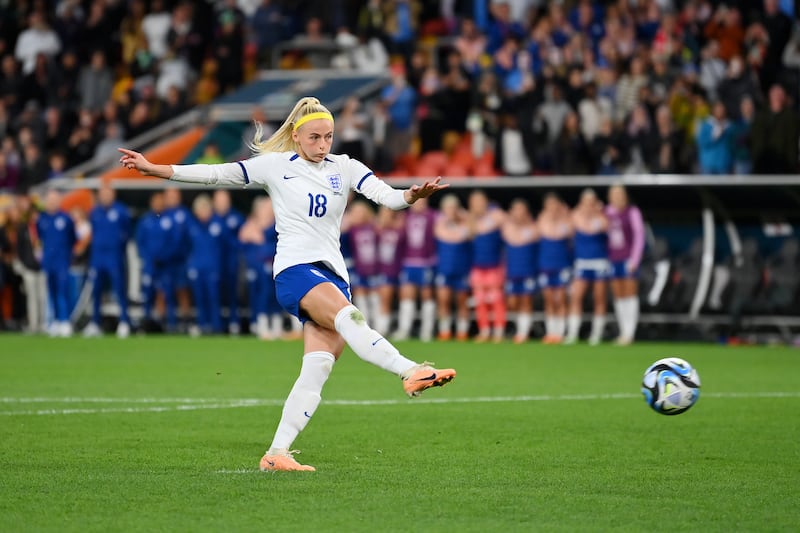 Chloe Kelly of England scores her team's fifth and winning penalty in the shoot out. Getty