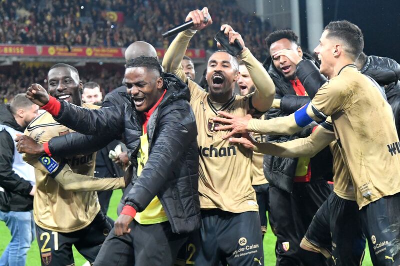 Lens players celebrate after their 3-1 win over Paris Saint-Germain at the Bollaert-Delelis Stadium in Lens, northern France on January 1, 2023. AFP