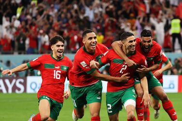 epa10352383 Players of Morocco celebrate with Achraf Hakimi (2-R) after he scored the last penalty kick which qualified Morocco to the quarter final during the FIFA World Cup 2022 round of 16 soccer match between Morocco and Spain at Education City Stadium in Doha, Qatar, 06 December 2022.  EPA/Mohamed Messara