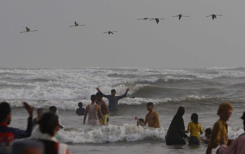 People gather at the beach to beat the hot weather during lockdown in Karachi, Pakistan. EPA