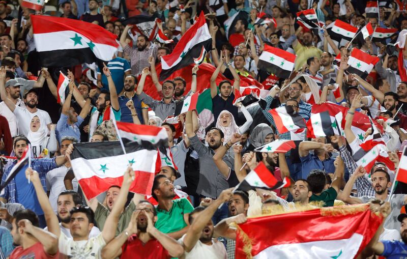 Fans cheer Syria on in Iran. Abedin Taherkenareh / EPA