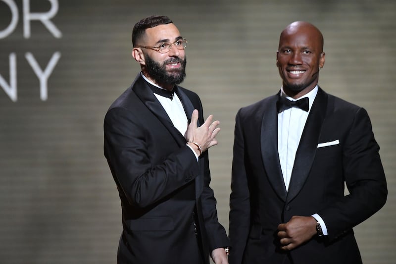 Real Madrid striker Karim Benzema and former Chelsea striker Didier Drogba speak on stage during the Ballon d'Or ceremony at Theatre Du Chatelet in Paris. Getty Images