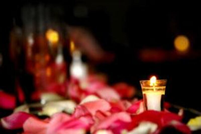 Tea lights and white candles in assorted sizes lend a romantic look to the room.