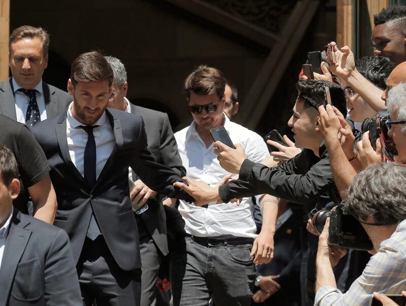 Lionel Messi, left, leaves the court in Barcelona on Thursday. Messi denied having knowledge of the tax issues that led to fraud charges against him. Manu Fernandez / AP Photo