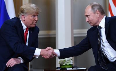 Russian President Vladimir Putin (R) and US President Donald Trump shake hands before a meeting in Helsinki, on July 16, 2018.  / AFP / Brendan Smialowski
