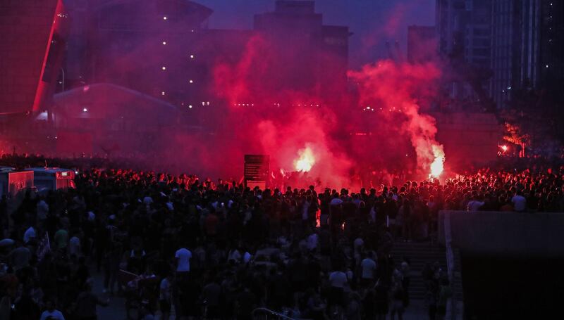 Liverpool fans let off flares outside the Liver Building in Liverpool. PA