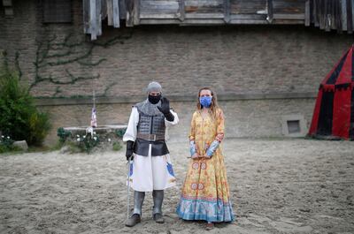 FILE PHOTO: Actors wearing protective masks pose after a rehearsal at French theme park Le Puy du Fou before its reopening with health and safety measures following the coronavirus outbreak, in Les Epesses, France, June 5, 2020. REUTERS/Stephane Mahe/File Photo