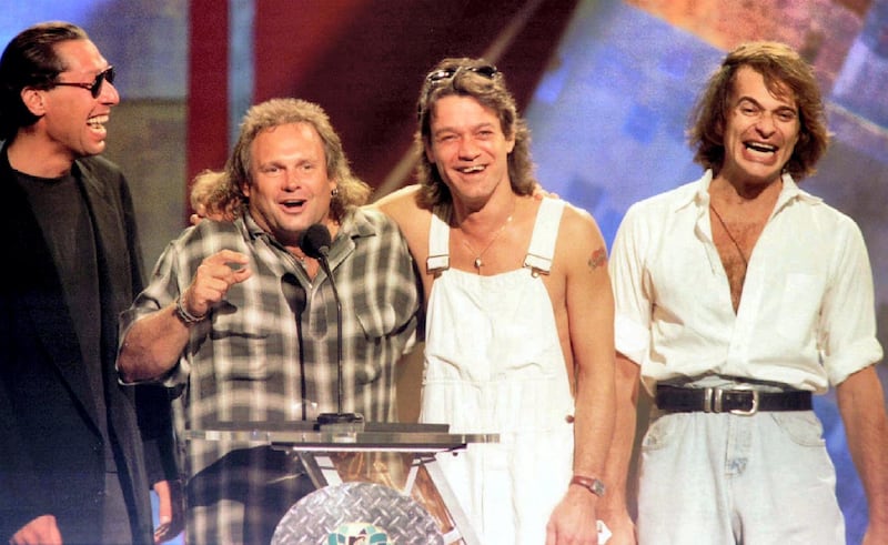 Members of the band Van Halen (L-R) Alex Van Halen, Michael Anthony, Eddie Van Halen are reunited with former lead singer David Lee Roth (R) on stage at the 1996 MTV Video Music Awards in New York on September 4.