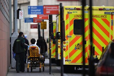 A patient is wheeled into the Royal London hospital in London on January 12, 2021 as surging cases of the novel coronavirus are placing health services under increasing pressure.  / AFP / DANIEL LEAL-OLIVAS
