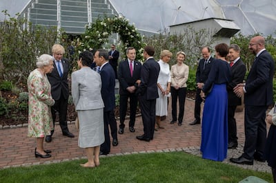 ST AUSTELL, ENGLAND - JUNE 11: British Prime Minister Boris Johnson (2nd L) chats with Queen Elizabeth II and Japanese Prime Minister Yoshihide Suga and his wife Mariko Suga as he hosts a drinks reception for Queen Elizabeth II and G7 leaders at at The Eden Project during the G7 Summit on June 11, 2021 in St Austell, Cornwall, England. UK Prime Minister, Boris Johnson, hosts leaders from the USA, Japan, Germany, France, Italy and Canada at the G7 Summit. This year the UK has invited India, South Africa, and South Korea to attend the Leaders' Summit as guest countries as well as the EU. (Photo by Jack Hill - WPA Pool / Getty Images)
