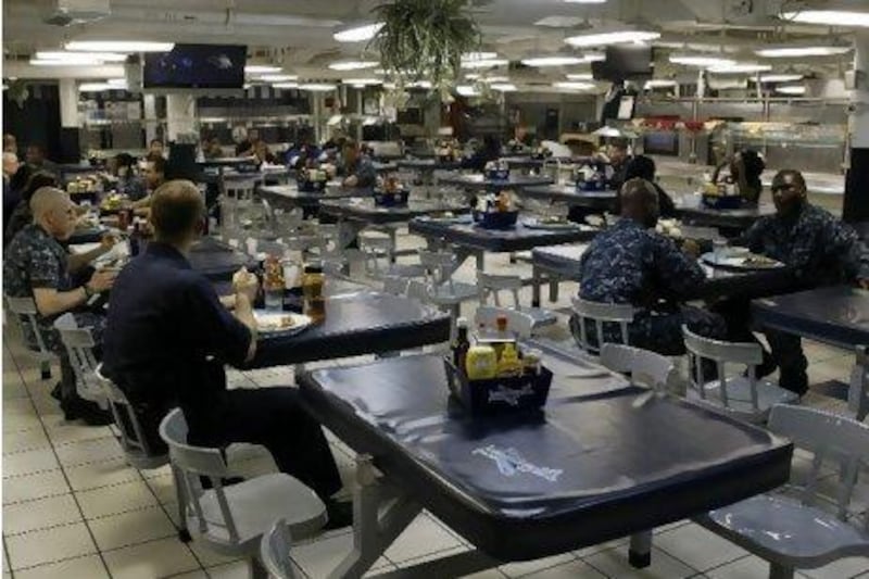 Sailors having lunch in one of the dining areas on board the George H. W. Bush aircraft carrier in port at Jebel Ali.