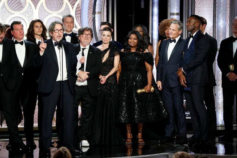 This image released by NBC shows Peter Farrelly, foreground, accepting the award for best comedy film for "Green Book" during the 76th Annual Golden Globe Awards at the Beverly Hilton Hotel on Sunday, Jan. 6, 2019, in Beverly Hills, Calif. (Paul Drinkwater/NBC via AP)