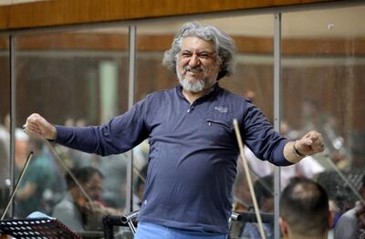 Iraqi National Symphony Orchestra conductor Mohammed Amin Ezzat leads musicians during a rehearsal on August 5, 2018 at Baghdad's School of Music and Ballet. - Some 40 musicians are gearing up to play at Baghdad's National Theatre on August 18, but the group's morale is at an all time low. The ensemble has lost more than half its members since the beginning of the year, when Baghdad introduced a directive barring state employees with two jobs from receiving two salaries. (Photo by SABAH ARAR / AFP)