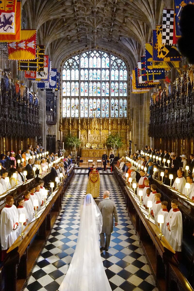 Prince Charles leads Meghan Markle up the aisle during her wedding to Prince Harry in St George's Chapel at Windsor Castle in 2018