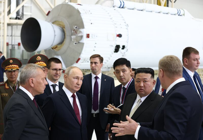 Mr Putin and Mr Kim were accompanied by head of Russian state space corporation Roscosmos Yuri Borisov, left, during the visit. EPA