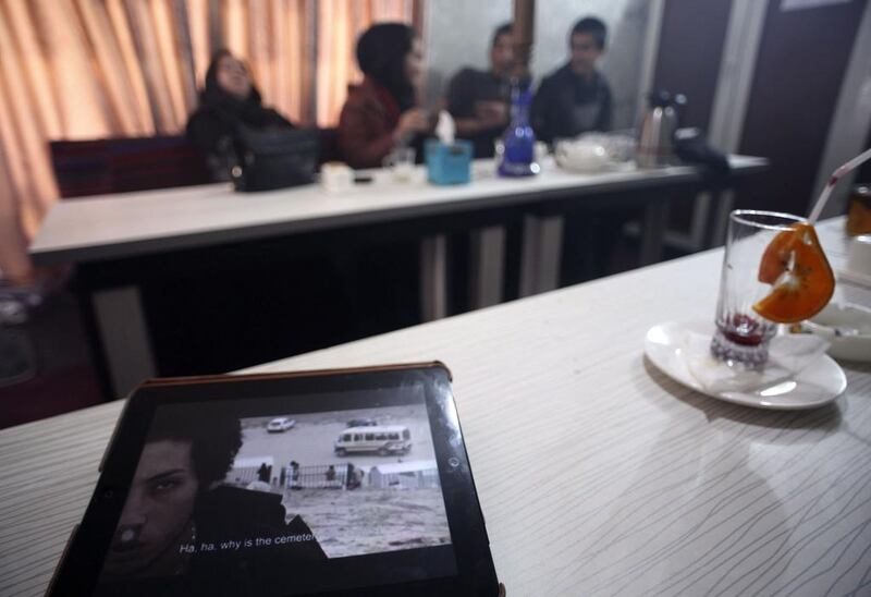 A video clip of Afghan singer Matin plays on an iPad in a cafe.