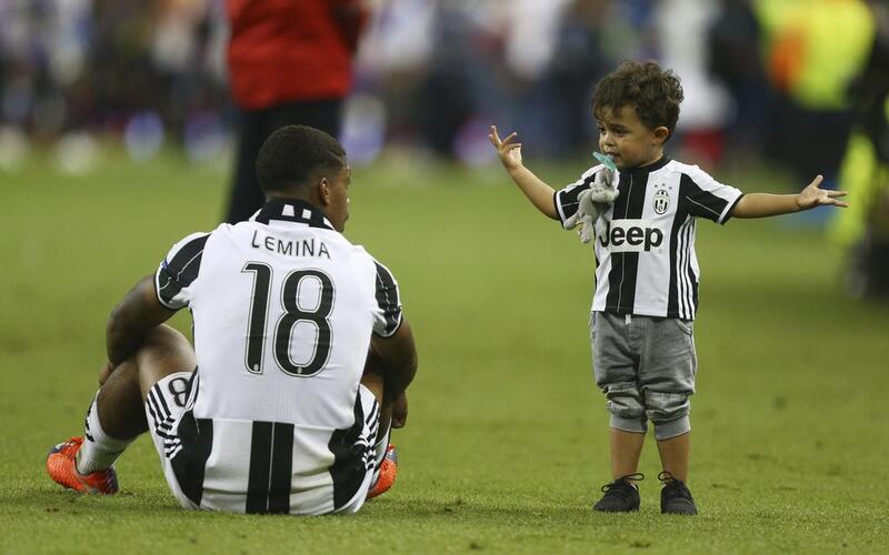 What went wrong dad? Juventus midfielder Mario Lemina sits next to his son after his club’s Champions League defeat to Real Madrid in Cardiff. Dave Thompson / AP Photo