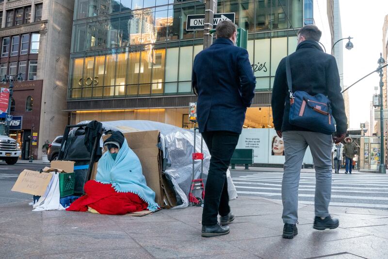 A homeless person sits with their belongings on a New York pavement. Saturdays attacks took place between 4.30am and 6am, while the victims were asleep. Reuters