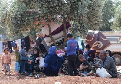 Displaced Syrians sit together in an olive grove in Atmeh town, Idlib province, Syria May 15, 2019. Picture taken May 15, 2019. REUTERS/Khalil Ashawi