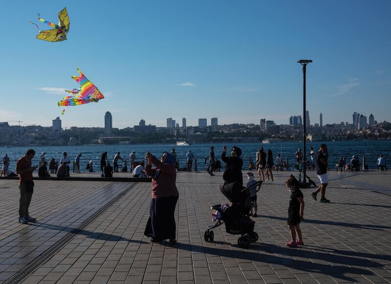 Women fly kites with their children, in Istanbul, Turkey. EPA