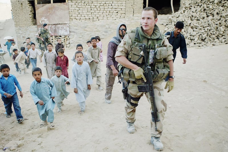 KABUL, AFGHANISTAN - OCTOBER 4: A Norwegian ISAF (International Security Assistance Force)soldier from Recce Squadron 3 patrols on October 4, 2004 in Kabul, Afghanistan as election officials get ready for the Presidential elections. On October 9th, Afghans will have the chance to vote for the first time in a direct election choosing a presidential candidate. The election is seen as a crucial step towards democracy and peace in the war-torn country after the fall of the Taliban. (Photo by Paula Bronstein/Getty Images)