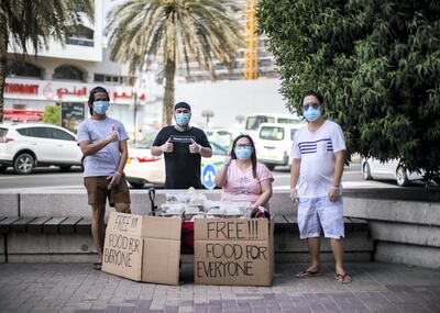 DUBAI, UNITED ARAB EMIRATES. 31 MAY 2020. 

Feby Cachero Baguisa, a Filipina mother of three and aspiring chef. For the past few days at 3PM, Feby has been sitting by the Patchi Building in Al Muraqabat Street in Deira, Dubai, with boxes of food she’s cooked at home, free for anyone who needs it.
(Photo: Reem Mohammed/The National)

Reporter:
Section: