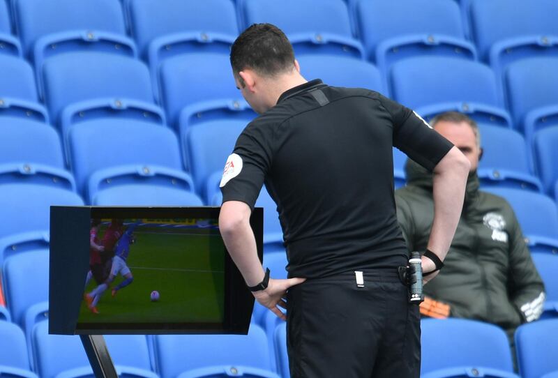 Referee Chris Kavanagh looks at a monitor of a replay of an incident involving Brighton's Aaron Connolly and Manchester United's Paul Pogba. Reuters