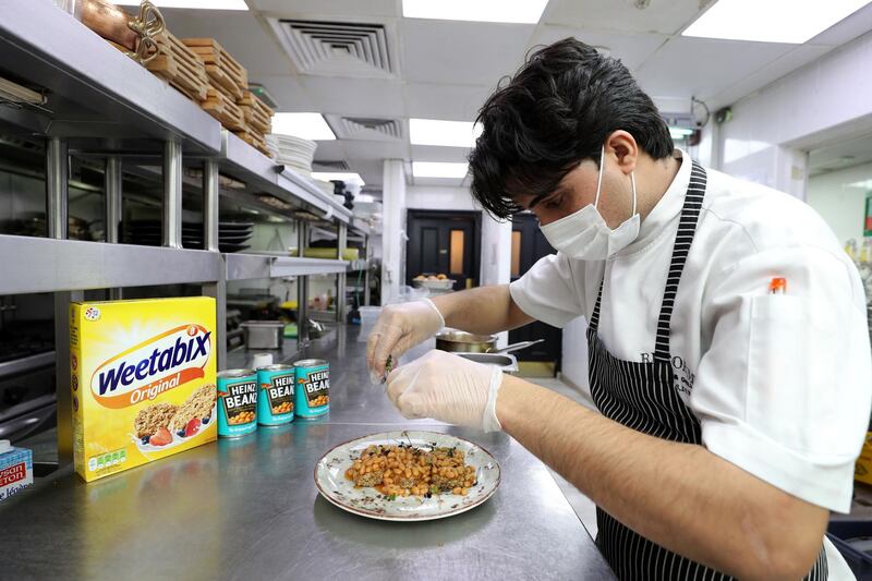 Dubai, United Arab Emirates - Reporter: N/A. Lifestyle. Sous Chef Usama Shah prepares the baked beans of Weetabix. Reform Social & Grill have started seeing baked beans and wheetabix plus there own concoctions. Tuesday, February 16th, 2021. Dubai. Chris Whiteoak / The National