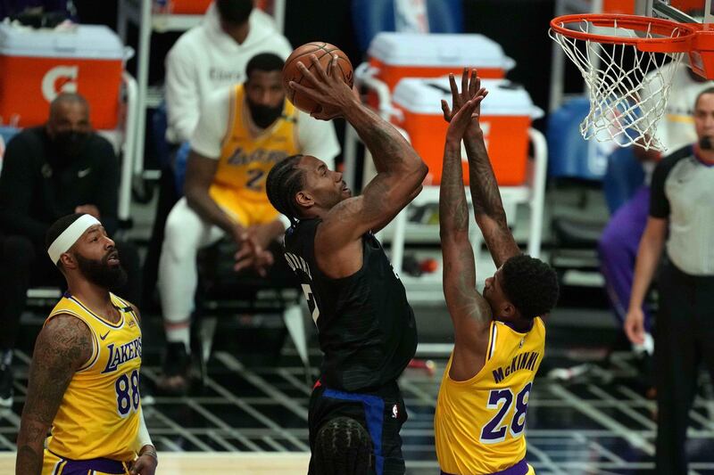 May 6, 2021; Los Angeles, California, USA; LA Clippers forward Kawhi Leonard (2) shoots the ball between Los Angeles Lakers forward Alfonzo McKinnie (28) and forward Markieff Morris (88)  in the second half at Staples Center. Mandatory Credit: Kirby Lee-USA TODAY Sports