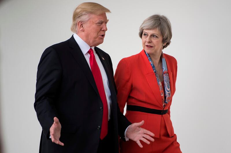 (FILES) This file photo taken on January 27, 2017 shows US President Donald Trump and British Prime Minister Theresa May walking to a press conference at the White House in Washington, DC.
Britain was reeling Thursday after US President Donald Trump castigated Prime Minister Theresa May over her rebuke to him for posting anti-Muslim tweets, but the government sought to play down the row. / AFP PHOTO / Brendan Smialowski