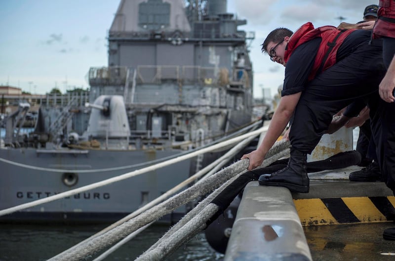 A sailor heaves line in preparation ahead of Hurricane Florence at Naval Station Norfolk in Norfolk, Virginia. Reuters