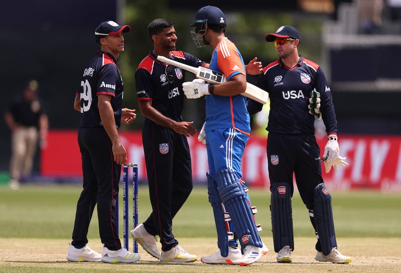 Players shake hands at the end of the match after India has secured victory with 10 balls remaining. AFP
