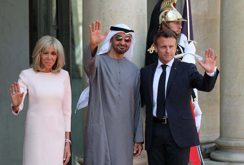 Sheikh Mohamed with Mr Macron and France's first lady Brigitte Macron after the UAE President's arrival at Elysee Palace in the French capital. Chris Whiteoak / The National