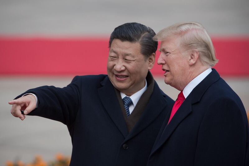 (FILES) In this file photo taken on November 9, 2017 China's President Xi Jinping (L) and US President Donald Trump attend a welcome ceremony at the Great Hall of the People in Beijing.  US President Donald Trump and Chinese leader Xi Jinping will "probably" meet at a G20 summit next month, a US official said October 14, 2018, as both sides deplored a badly strained relationship that a Chinese official called "very confusing." "The presidents will probably meet at the G20 in Buenos Aires," Trump economic adviser Larry Kudlow said on the "Fox News Sunday" program.
 / AFP / NICOLAS ASFOURI

