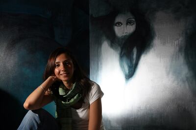 March 4, 2009 / Dubai /  Artist Fawz Kabra, 28, poses in front of some of her art work at her Abu Dhabi home March 4, 2009.  (Sammy Dallal / The National) *** Local Caption ***  sd-030409-artist-04.jpg