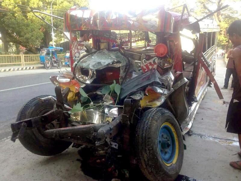 This photo provided by Land Transportation Franchise and Regulatory Board (LTFRB) shows the wreckage of a passenger van in La Union province, Philippines following an early morning collision with a passenger bus Monday, Dec. 25, 2017. A passenger bus collided with the van carrying pilgrims to Christmas Mass at a church in the northern Philippines, causing casualties and more than two dozen injured. (AP Photo/LTFRB via AP)