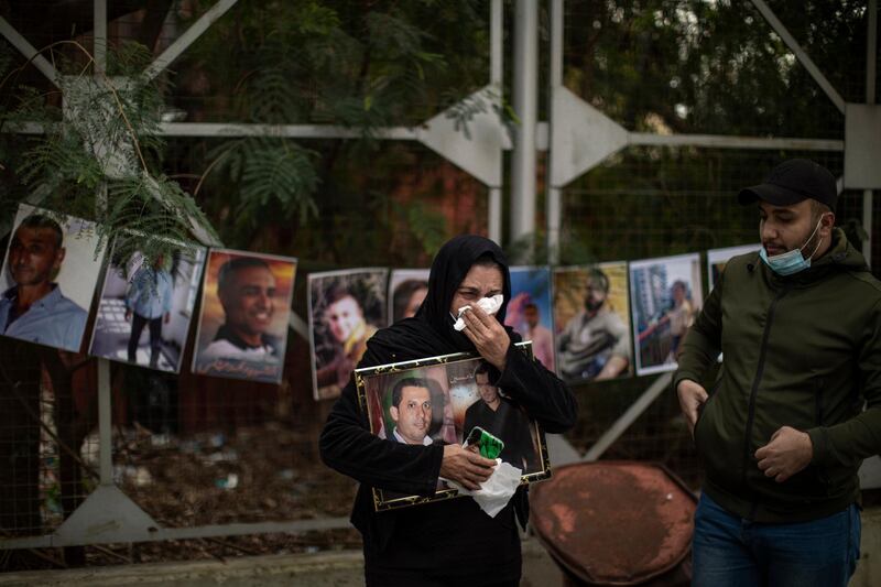 Family members of the Beirut explosion victims hold photos of their loved ones while demanding the truth about the cause of the explosion. Getty Images