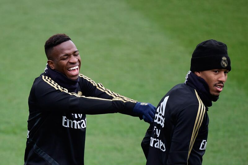 Real Madrid's Brazilian forward Vinicius Junior (L) and defender Eder Militao joke during a training session at the Real Madrid City sports facility in Madrid. AFP