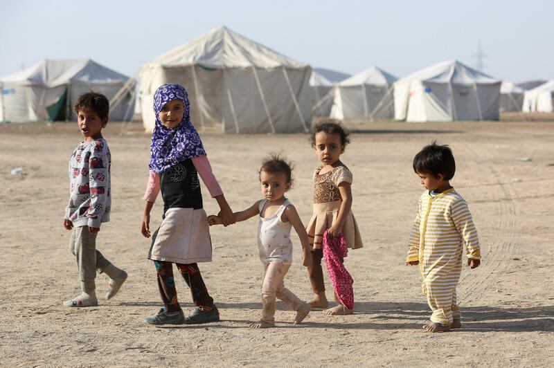 Children walk at a camp for people recently displaced by fighting in Yemen's northern province of al-Jawf between government forces and Houthis, in Marib, Yemen March 8, 2020. Picture taken March 8, 2020. REUTERS/Ali Owidha     TPX IMAGES OF THE DAY