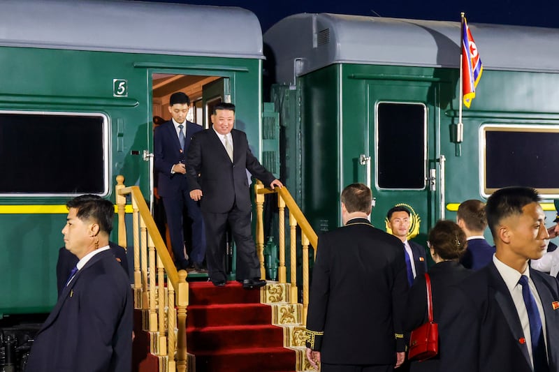 Mr Kim disembarks from his train after crossing the border to Russia at Khasan on Tuesday. AP