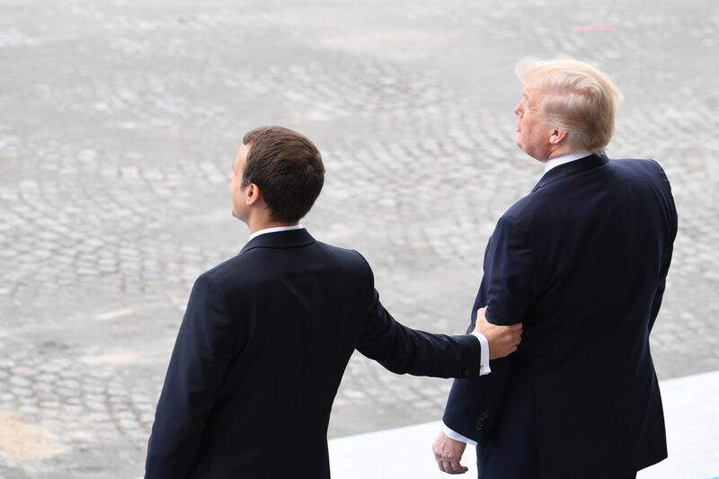 (FILES) This file photo taken on July 14, 2017 shows French President Emmanuel Macron (L) gesturing next to US President Donald Trump (R) during the annual Bastille Day military parade on the Champs-Elysees avenue in Paris.
Donald Trump's first year in office has been a gripping spectacle of scandal, controversy and polarization that has utterly transformed the way Americans and their president interact. Many presidents have tried to bypass a critical media -- from Franklin Roosevelt's fireside chats to Barack Obama's interviews with YouTubers. But Trump has taken that into overdrive on Twitter.From one day to the next, he is rarely out of the headlines or off the air, permeating every facet of public life.  / AFP PHOTO / ALAIN JOCARD