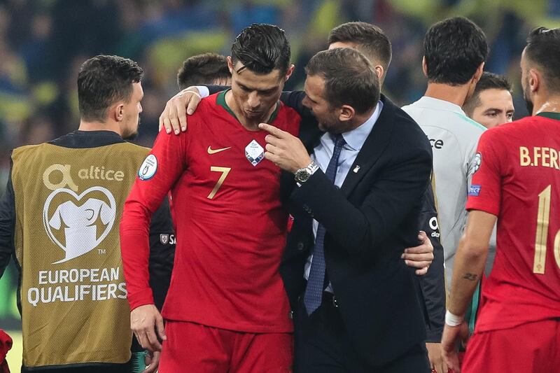 Portugal`s Cristiano Ronaldo with Ukraine head coach Andriy Shevchenko after the match. EPA