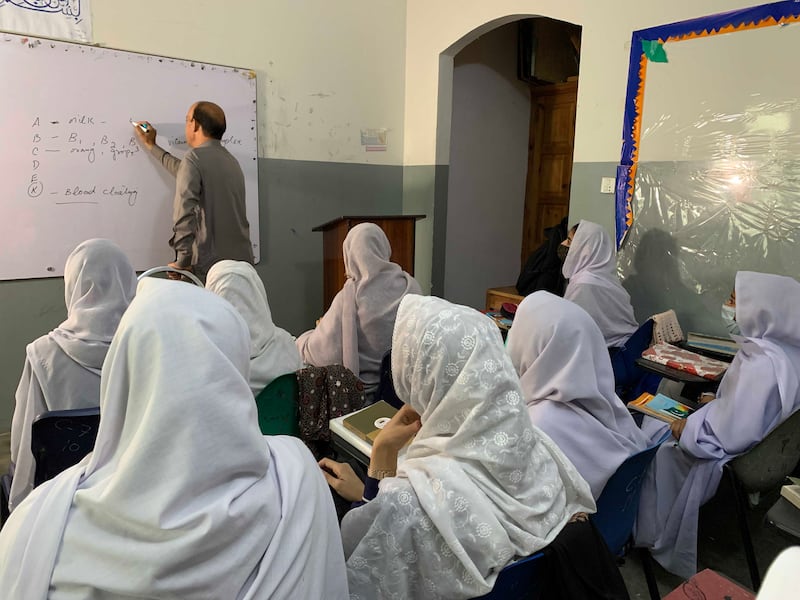 Iqbal Hussain, a member of the faculty at Khushal School and College in Pakistan's Swat region where Malala Youafzai was a pupil, teaches science to 10th grade pupils. All photos: Tariq Ullah for The National